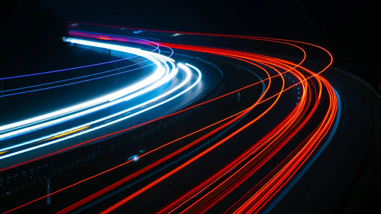 Long-exposure light trails of cars driving at night