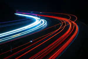 Long-exposure light trails of cars driving at night